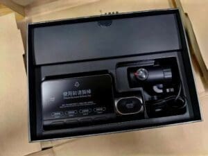 Unboxed dash cam and accessories in a black organizer tray